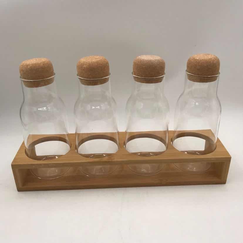 4-Piece Glass Bottle Set with Cork Stoppers on Bamboo Rack