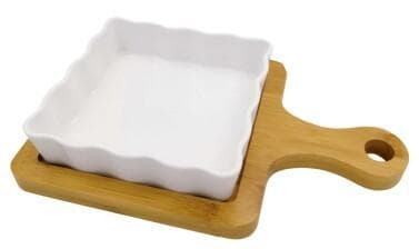 Square Ruffled Ceramic Baking Dish on Bamboo Paddle Board