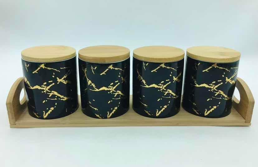 4-Piece Black and Gold Marble-Effect Ceramic Canister Set with Bamboo Lids on Bamboo Tray