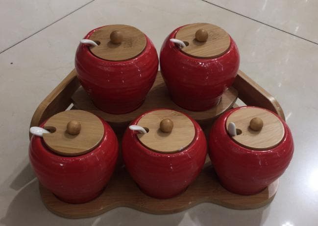 6-Piece Red Ceramic Condiment Jar Set with Bamboo Lids and Spoons on Bamboo Tray