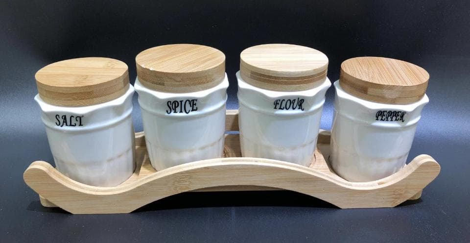 4-Piece Ceramic Spice Jar Set with Bamboo Lids on Arched Bamboo Stand