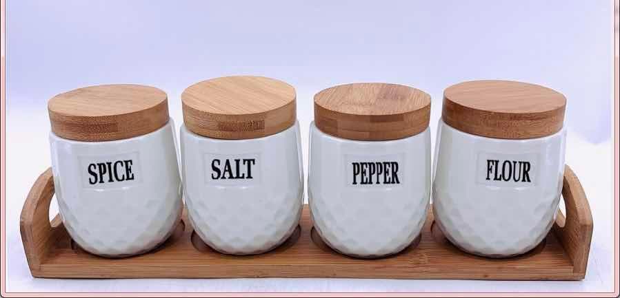 4-Piece Dimpled Ceramic Spice Jar Set with Bamboo Lids on Bamboo Tray