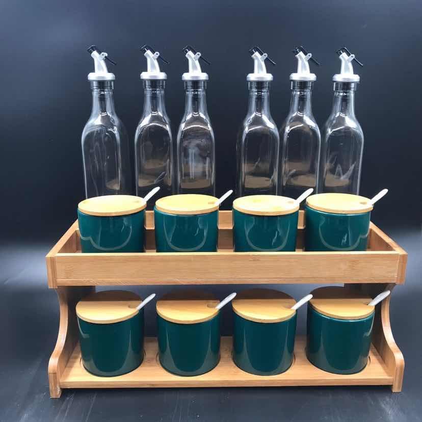 8-Bottle Glass Oil Set with Green Ceramic Condiment Jars on Wooden Rack
