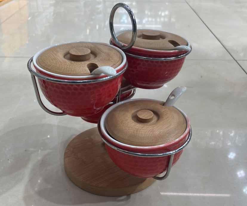 4-Piece Red Ceramic Condiment Bowl Set with Bamboo Lids and Spoons on Rotating Base