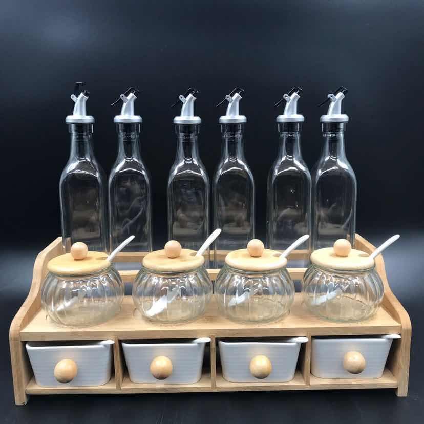 Glass Oil and Vinegar Bottle Set with Ceramic Condiment Jars on Wooden Rack