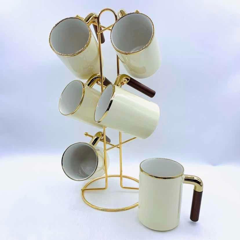 6-Piece Gold-Rimmed Ceramic Mug Set with Wooden Handles on Gold Metal Mug Tree, Cream Yellow